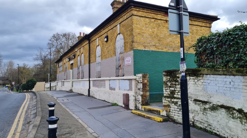 The boarded up remains of Woodside station. The northbound platform for the trams can be accessed through the gap in the wall in the forecourt.